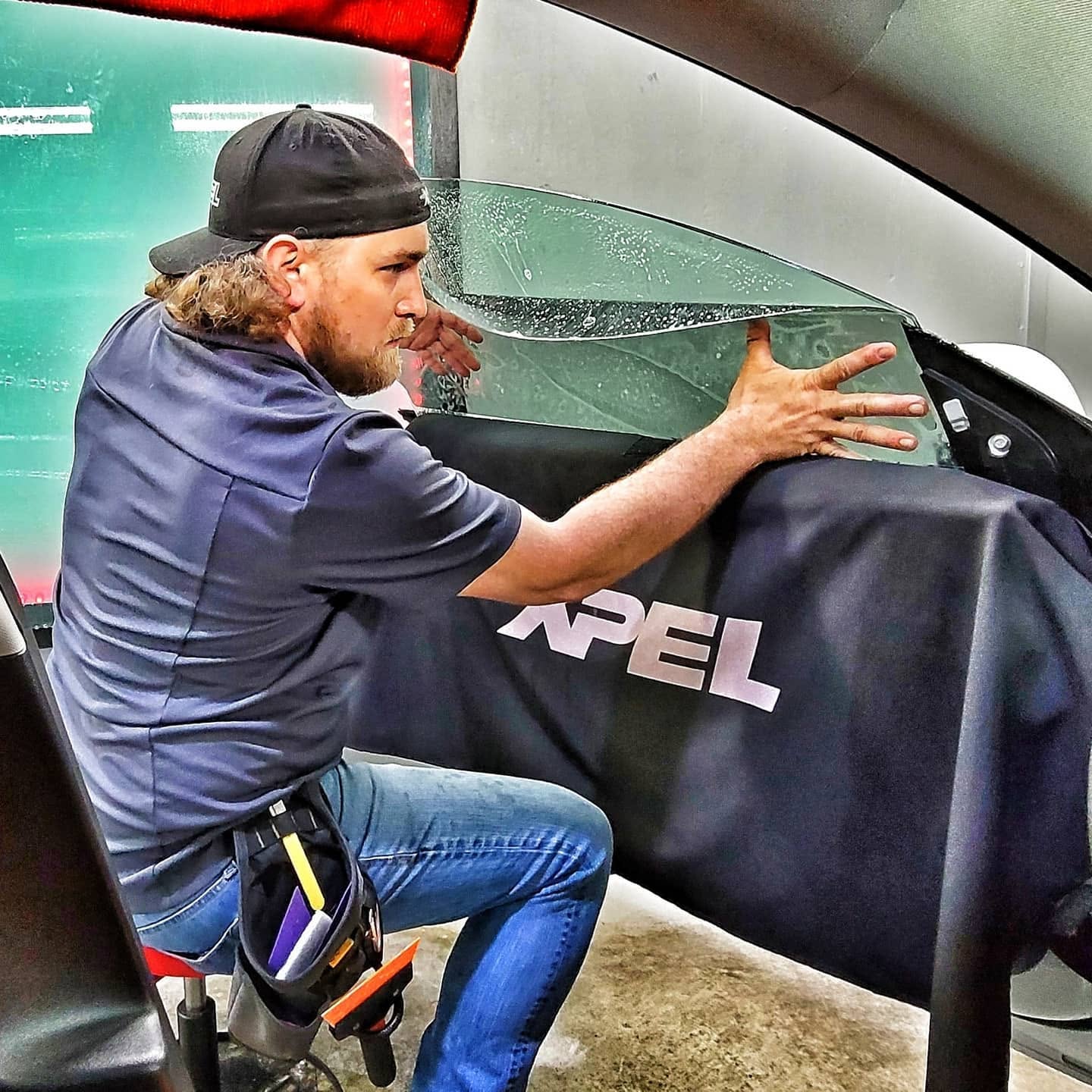 Technician working on automotive window film